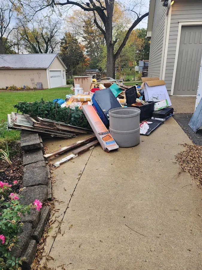 Dumpster being loaded with debris for 12 Yard Dumpster Rental in San Antonio